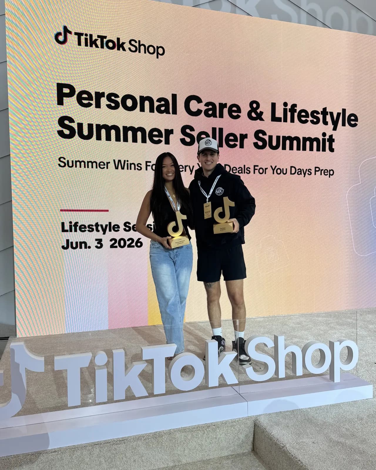 Trophies in hand in front of the TikTok Shop Summer Seller Summit stage